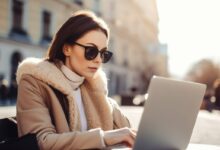 personality test - woman in sunglases typing on laptop